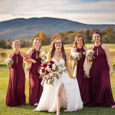 Bride and her bridesmaids wear maroon dresses during a joyful wedding celebration in Crozet, VA