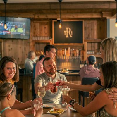 People gathered at a bar, sipping drinks together during breakfast in Crozet, VA